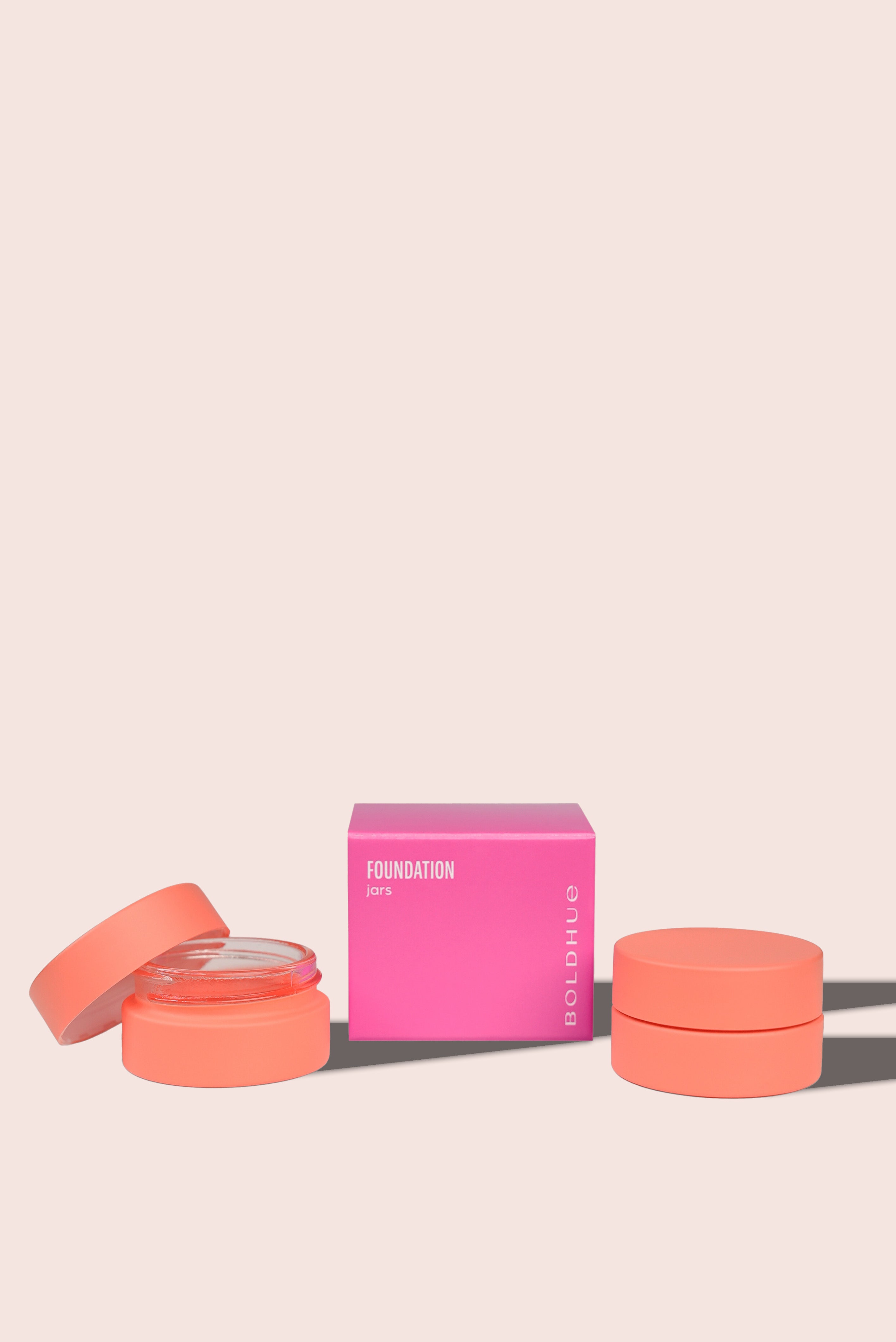 a bright pink box packaging reveals two blush colored storage jars for the boldhue device